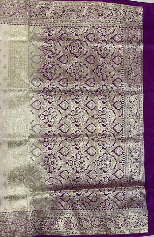 Humairah_Presents_Off-white_Katan_Silk_Floral_Light_Gold_Zari_Booti_with_Contrast_Purple_Floral_Pallu_Banarasi_saree_and_Purple_Blouse