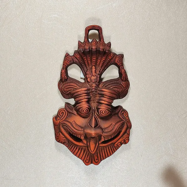 Wall_Hanging_Metal_Face_Mask_Nazar_Battu_Evil_Eye_Protector,_Wall_Mounted_Nazar_Suraksha_Kawach,_Evil_Eye_Hanging_for_Home_&_Office_Entrance_(Copper_-_16.5_x_3_x_9.5_cm)