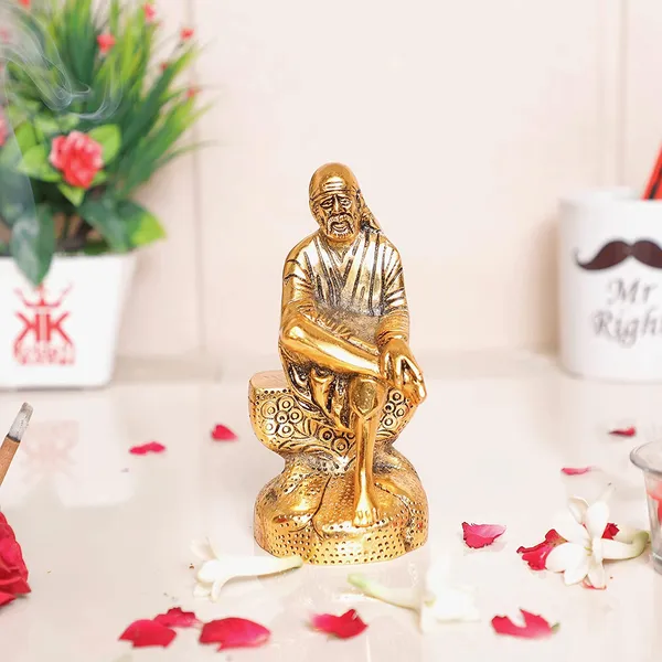DreamKraft_Shirdi_Sai_Baba_Metal_Idol_on_Rock-Style_Base,_Gold_Colour,_15_cm_Height