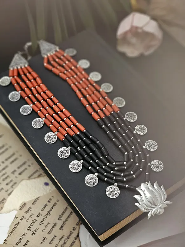 Utpala_Multi-Layered_Red_and_Black_Beaded_Necklace_with_Silver_Lotus_Pendant
