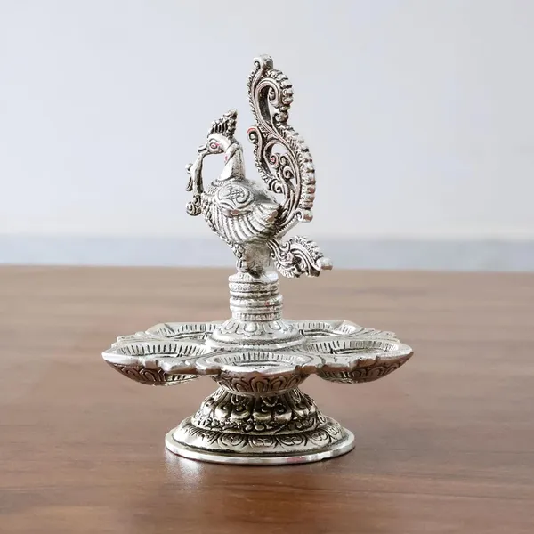Traditional_Silver-Plated_Peacock_Pooja_Thali,_5-Compartment_Diya_Stand_with_Ornate_Design