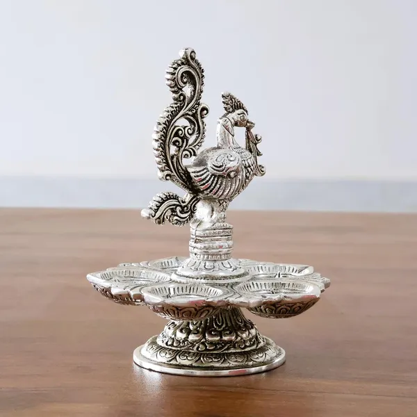 Traditional_Silver-Plated_Peacock_Pooja_Thali,_5-Compartment_Diya_Stand_with_Ornate_Design