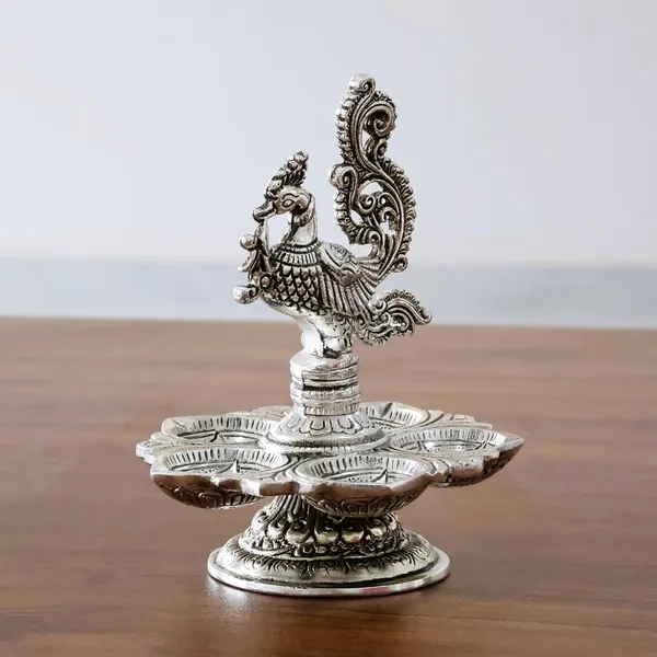 Traditional_Silver-Plated_Peacock_Pooja_Thali,_5-Compartment_Diya_Stand_with_Ornate_Design