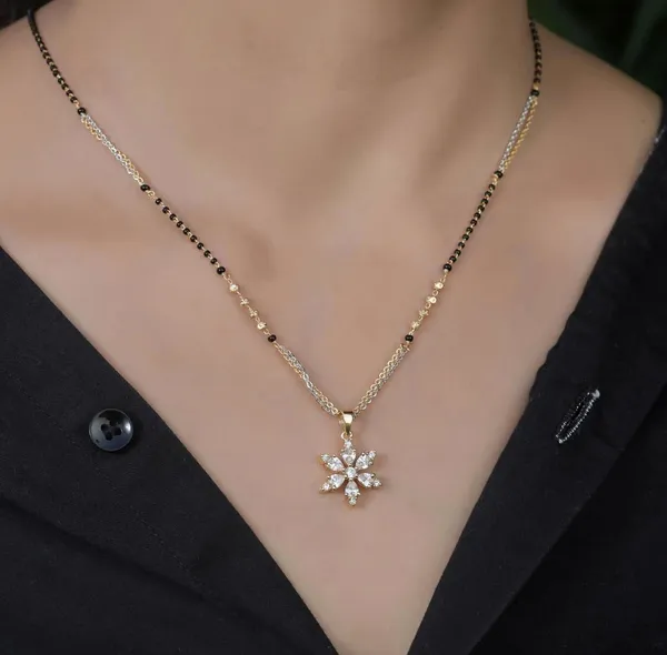 https://d1311wbk6unapo.cloudfront.net/NushopCatalogue/tr:f-webp,w-600,fo-auto/63b013893de9670012c6650a/cat_img/Star_2_tone_mangalsutra_ONVJYZ5TUG_2024-10-15_1.jpeg__Vamayukt