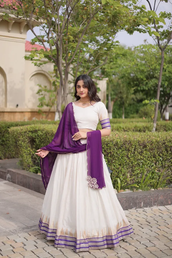 Comfortable_&_lightweight_white_Viscose_Jacquard_Lehenga_Choli_with_Dupatta,_perfect_for_your_Onam_festive_wardrobe._Elegant,_graceful_&_easy_to_wear_�_comes_with_an_unstitched_blouse_for_a_custom_fit.