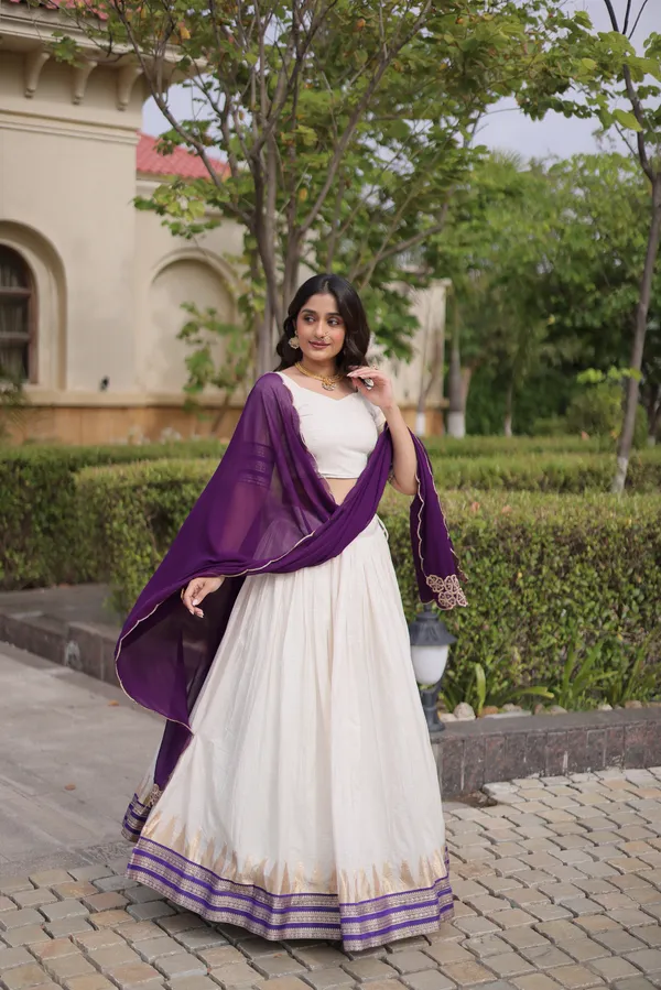 Comfortable_&_lightweight_white_Viscose_Jacquard_Lehenga_Choli_with_Dupatta,_perfect_for_your_Onam_festive_wardrobe._Elegant,_graceful_&_easy_to_wear_�_comes_with_an_unstitched_blouse_for_a_custom_fit.