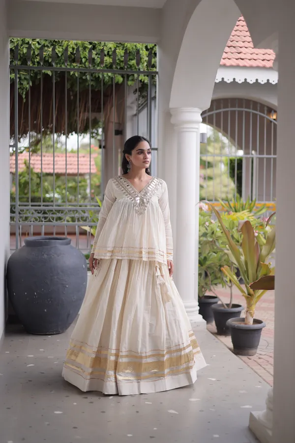 Elegant_Kora_Cotton_Lehenga_designed_with_beautiful_Zari_Patta_and_Gota_Patti_lace_work,_giving_a_rich_traditional_look._Paired_with_a_stitched_blouse_�_perfect_for_festive_and_Navratri_wear._?