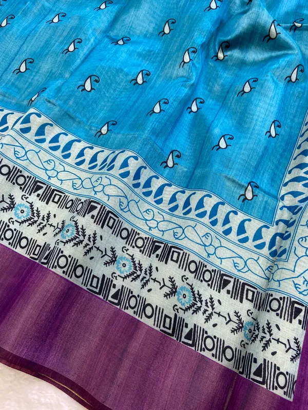 Urvi_Purple_&_Sky_Blue_–_Festive_Season_Special_|_Soft_Tussar_Silk_Saree_with_Print,_Border_&_Contrast_Print_Blouse_with_Tassels