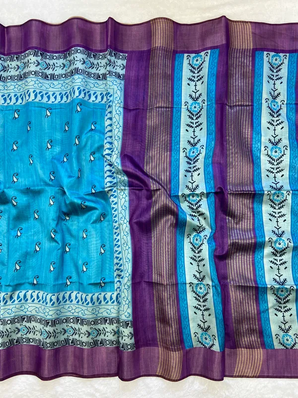 Urvi_Purple_&_Sky_Blue_–_Festive_Season_Special_|_Soft_Tussar_Silk_Saree_with_Print,_Border_&_Contrast_Print_Blouse_with_Tassels
