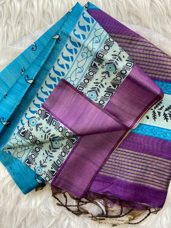 Urvi_Purple_&_Sky_Blue_–_Festive_Season_Special_|_Soft_Tussar_Silk_Saree_with_Print,_Border_&_Contrast_Print_Blouse_with_Tassels