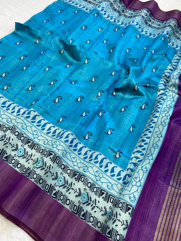 Urvi_Purple_&_Sky_Blue_–_Festive_Season_Special_|_Soft_Tussar_Silk_Saree_with_Print,_Border_&_Contrast_Print_Blouse_with_Tassels