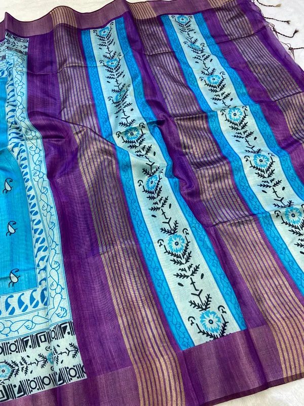 Urvi_Purple_&_Sky_Blue_–_Festive_Season_Special_|_Soft_Tussar_Silk_Saree_with_Print,_Border_&_Contrast_Print_Blouse_with_Tassels