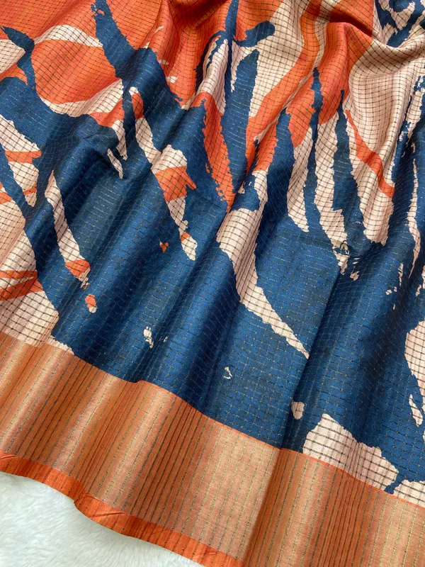 Aarathi_Blue_&_Orange_–_Aarti_Glow_Diwali_Special_|_Soft_Tussar_Silk_Saree_with_Digital_Print,_Checks_Design_Saree_&_Digital_Print_Blouse_with_Tassels