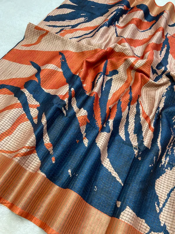 Aarathi_Blue_&_Orange_–_Aarti_Glow_Diwali_Special_|_Soft_Tussar_Silk_Saree_with_Digital_Print,_Checks_Design_Saree_&_Digital_Print_Blouse_with_Tassels