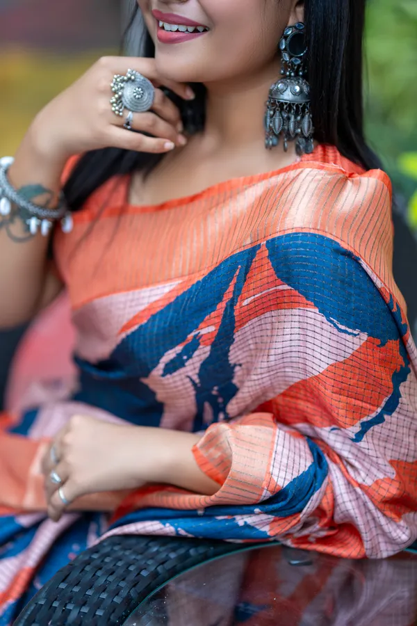 Aarathi_Blue_&_Orange_–_Aarti_Glow_Diwali_Special_|_Soft_Tussar_Silk_Saree_with_Digital_Print,_Checks_Design_Saree_&_Digital_Print_Blouse_with_Tassels