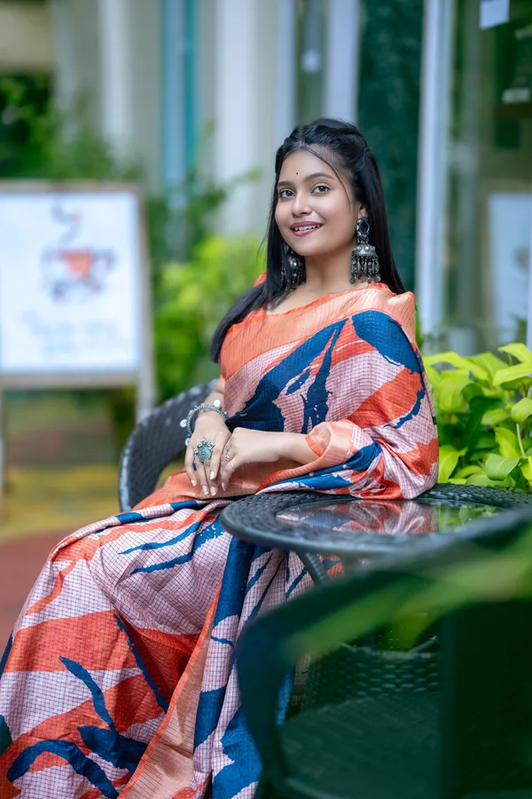 Aarathi_Blue_&_Orange_–_Aarti_Glow_Diwali_Special_|_Soft_Tussar_Silk_Saree_with_Digital_Print,_Checks_Design_Saree_&_Digital_Print_Blouse_with_Tassels