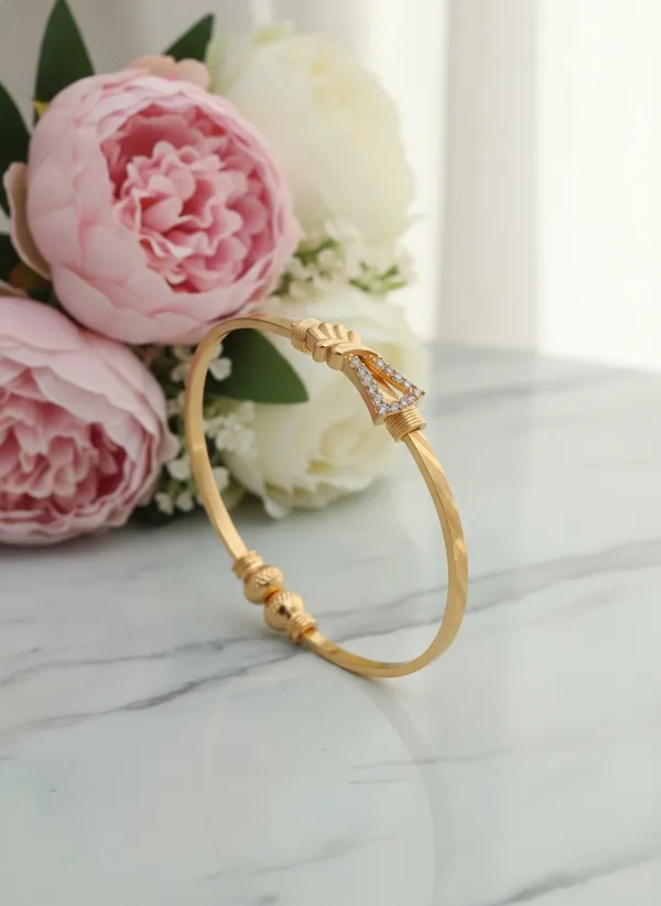 Delicate_Gold_Finish_Bangle_Bracelet_featuring_Pavé_Crystal_Knot_Motif