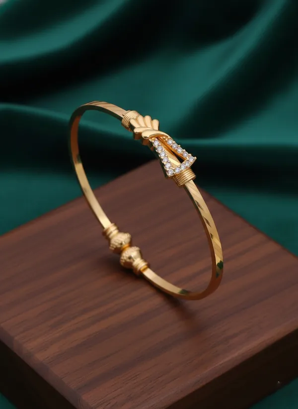 Delicate_Gold_Finish_Bangle_Bracelet_featuring_Pavé_Crystal_Knot_Motif