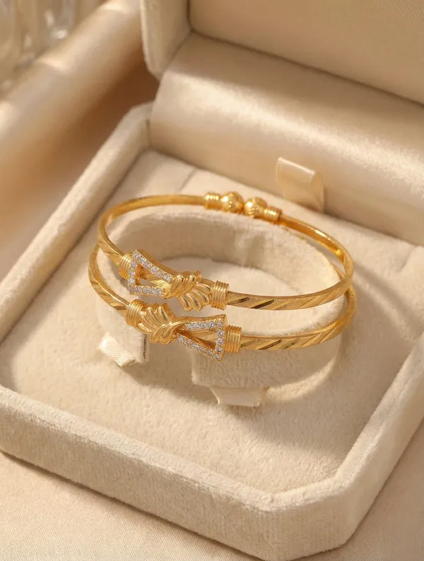 Elegant_Gold_Bangle_Pair_with_Floral_Accents_and_Cubic_Zirconia