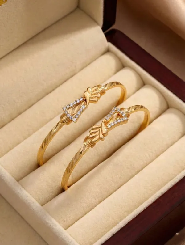 Elegant_Gold_Bangle_Pair_with_Floral_Accents_and_Cubic_Zirconia