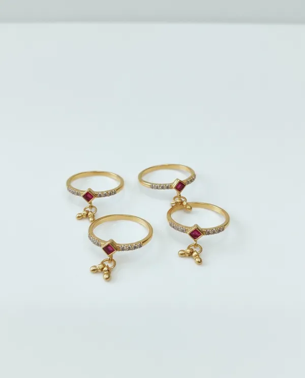 Gold_Rings_with_Ruby_Centerpiece_and_Dangling_Bead_Charms