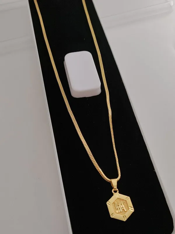 Gold-Toned_Hexagon_Pendant_Necklace_with_SWASTIK_Encraved