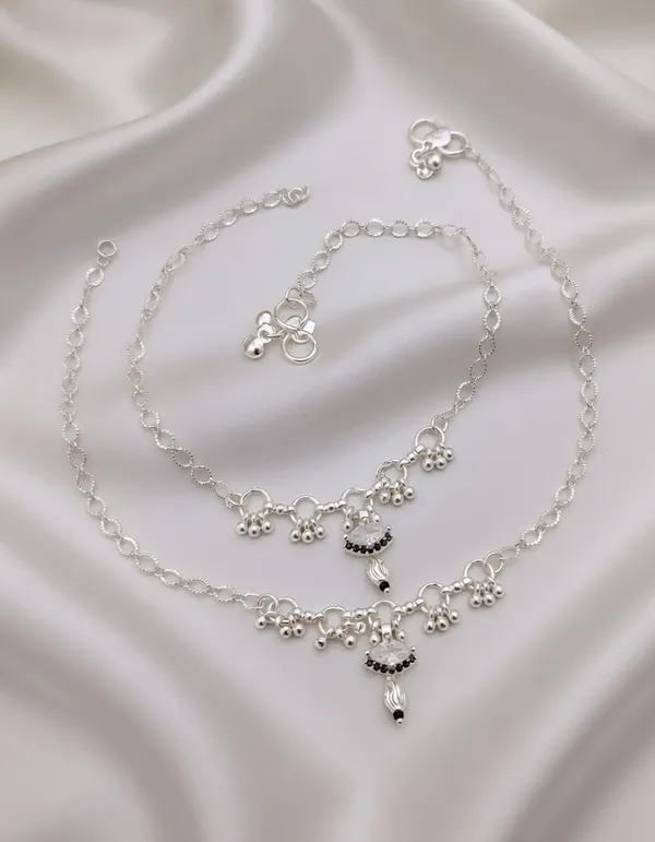 These_anklets_have_a_beautiful,_refined_look!_The_white_stone_center_with_the_black_bead_detailing_gives_them_a_very_"high-end_fusion"_feel_that_works_for_both_festive_occasions_and_everyday_elegance.__Here_is_the_SEO-optimized_content_for_Vihal_Jewellery.__Product_Title_Silver-Plated_White_Stone_&_Black_Bead_Drop_Anklets_with_Ghungroo_-_Pair_of_2_|_Vihal_Jewellery