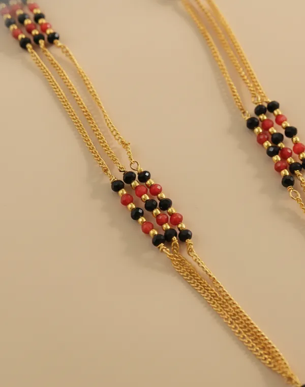 Traditional_Multi-Strand_Gold_and_Black_Bead_Mangalsutra_with_Floral_Pendants