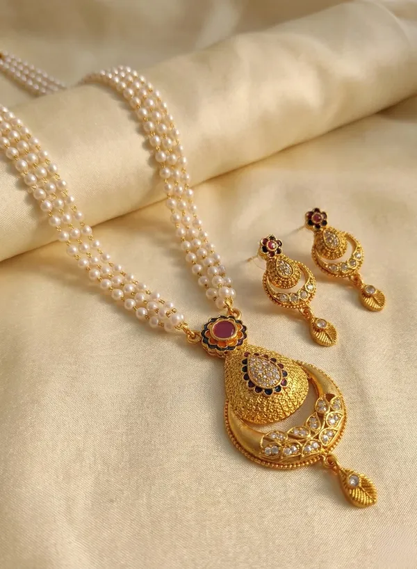 Traditional_Three-Strand_Pearl_Mala_with_Intricate_Gold-Tone_Pendant_and_Matching_Earrings