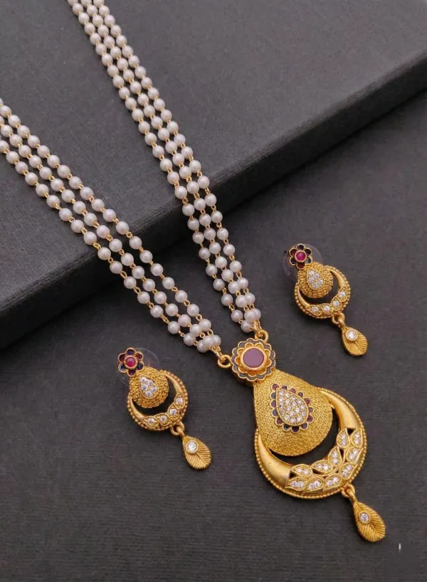 Traditional_Three-Strand_Pearl_Mala_with_Intricate_Gold-Tone_Pendant_and_Matching_Earrings