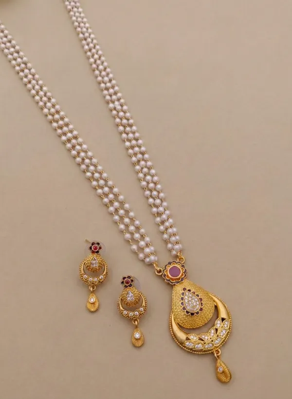 Traditional_Three-Strand_Pearl_Mala_with_Intricate_Gold-Tone_Pendant_and_Matching_Earrings