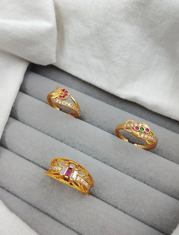 Trio_of_Intricate_Gold_Rings_with_Multi-Color_Gemstones