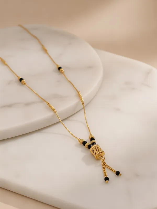 Dainty_Golden_Mangalsutra_with_Cylindrical_Bead_Pendant_and_Tassel_Detail
