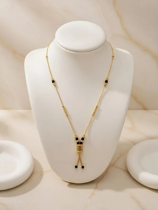 Dainty_Golden_Mangalsutra_with_Cylindrical_Bead_Pendant_and_Tassel_Detail
