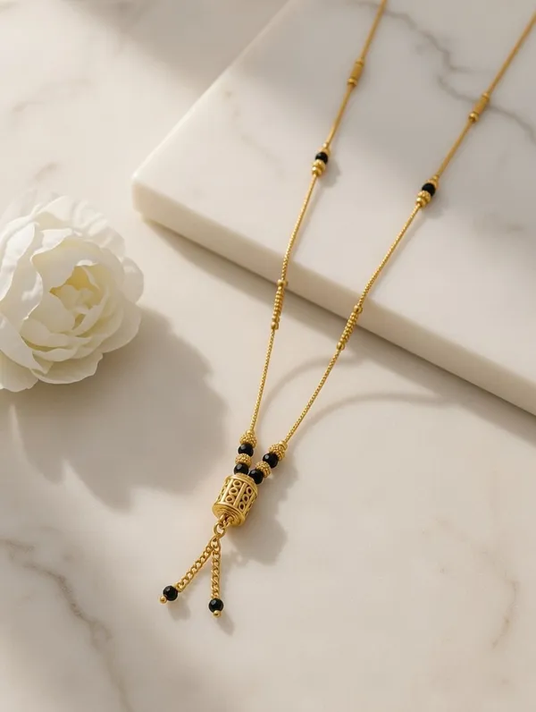 Dainty_Golden_Mangalsutra_with_Cylindrical_Bead_Pendant_and_Tassel_Detail