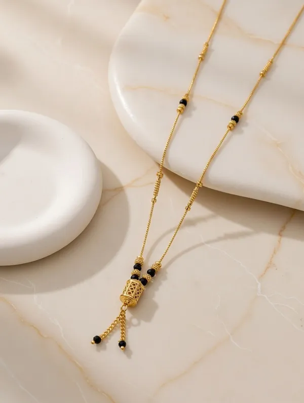 Dainty_Golden_Mangalsutra_with_Cylindrical_Bead_Pendant_and_Tassel_Detail