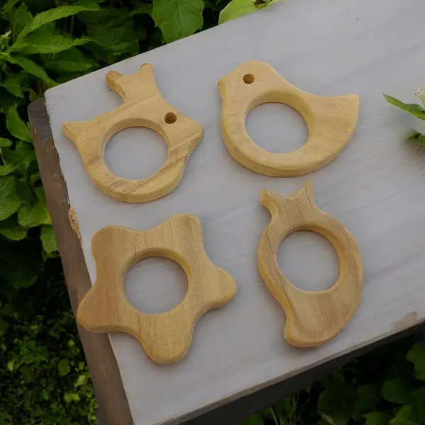 Pack_of_4__Neem_Wooden_Teethers-_Rabbit,_Flower,_Dove_&_Mango_Shapes