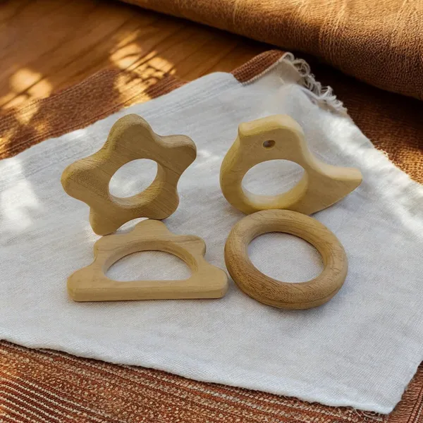 Pack_of_4_Neem_Wooden_Teethers_For_Babies_of_Age_0_To_3_Years_|_Ring,_Flower,_Dove_&_Cloud_Shapes