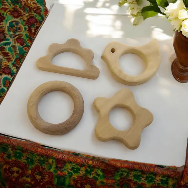 Pack_of_4_Neem_Wooden_Teethers_For_Babies_of_Age_0_To_3_Years_|_Ring,_Flower,_Dove_&_Cloud_Shapes