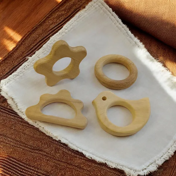 Pack_of_4_Neem_Wooden_Teethers_For_Babies_of_Age_0_To_3_Years_|_Ring,_Flower,_Dove_&_Cloud_Shapes