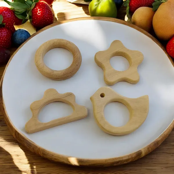 Pack_of_4_Neem_Wooden_Teethers_For_Babies_of_Age_0_To_3_Years_|_Ring,_Flower,_Dove_&_Cloud_Shapes