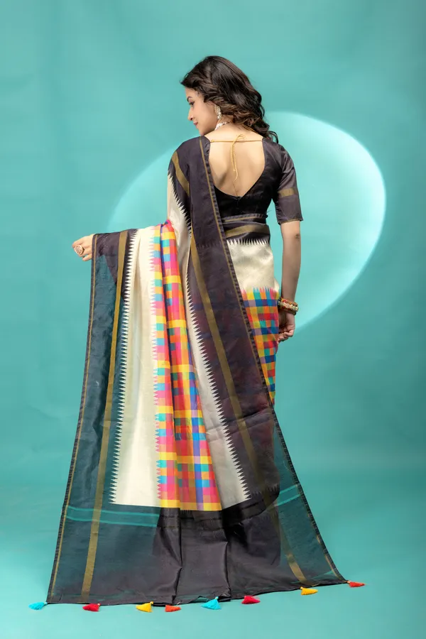 Soft_Tussar_Silk_sarees_with_Beautiful_Srikalahasti_Style_Of_Kalamkari_Digital_Print_With_Patola-style_Ikat:_The_central_multicolored_section_uses_a_digital_print_that_mimics_the_double-ikat_(Patola)_technique,_creating_a_blurred,_"grid-like"_geometric_effect_in_rainbow_hues._This_is_a_staple_in_traditional_South_Indian_textiles__And_Digital_Print_Blouse_With_Tassels