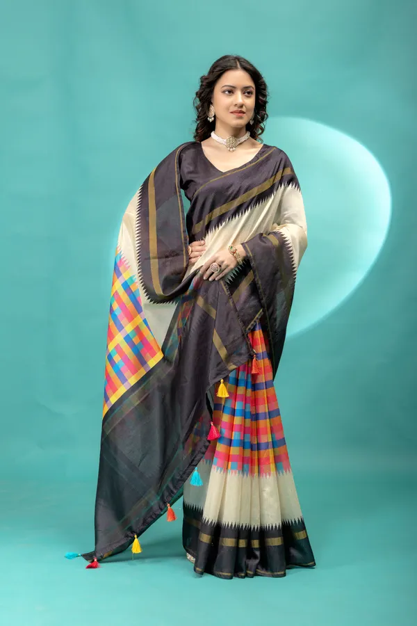 Soft_Tussar_Silk_sarees_with_Beautiful_Srikalahasti_Style_Of_Kalamkari_Digital_Print_With_Patola-style_Ikat:_The_central_multicolored_section_uses_a_digital_print_that_mimics_the_double-ikat_(Patola)_technique,_creating_a_blurred,_"grid-like"_geometric_effect_in_rainbow_hues._This_is_a_staple_in_traditional_South_Indian_textiles__And_Digital_Print_Blouse_With_Tassels