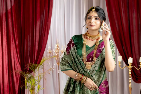 Banarasi_Pure_Satin_Silk_sarees_with_Beautiful_Peacock_in_Contrast_Green-Wine_Shades_With_Attractive_Weaving_Gold_Zari_Design_And_Contrast_Blouse_With_Tassels