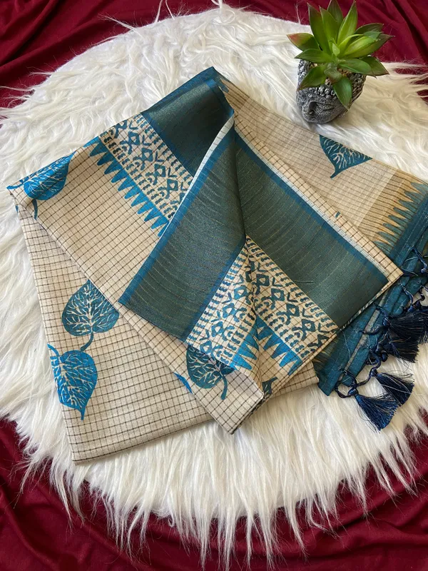 Soft_Tussar_Silk_sarees_with_Beautiful_Hand-Block_Inspired_Leaf_Digitel_Print:_The_primary_motif_consists_of_pipal_leaf_patterns_in_vibrant_shades_With_Temple_Border_The_serrated,_triangular_pattern_lining_the_is_a_classic_Indian_design_known_as_a_Temple_border_or_Temple_motif._This_is_a_staple_in_traditional_South_Indian_textiles_With_Attractive_Checks_Design_Saree_And_Digital_Print_Blouse_With_Tassels