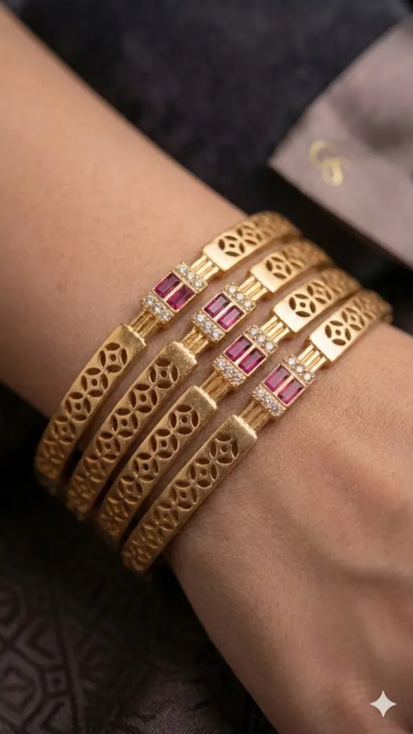 Add_A_Touch_Of_Royal_Elegance_To_Your_Jewelry_Collection_with_These_Beautifully_Crafted_Micro_Gold_Plated_And_&_Ruby_Stone_Studded_Bangles._Designed_with_Intricate_Floral_Cutwork_Detailing,_These_Bangles_Feature_A_Stunning_Centerpiece_Adorned_with_Sparkling_American_Diamonds_And_Rich_Ruby-Colored_Stones_That_Enhance_Their_Luxurious_Appeal.
