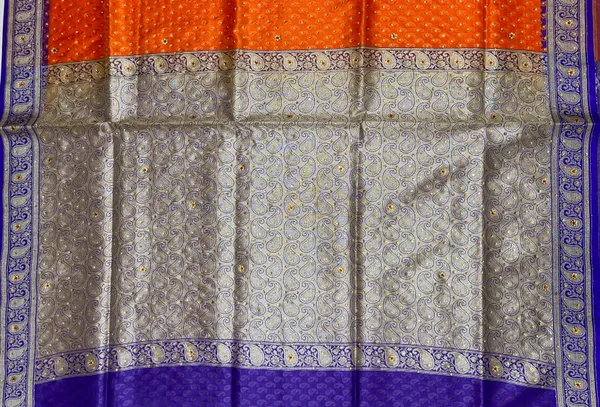 Humairah_Presents_Orange_Tanchoi_Silk_Low_Stone_Work_with_Contrast_Blue_Pallu_Zari_Border_and_Purple_Blouse
