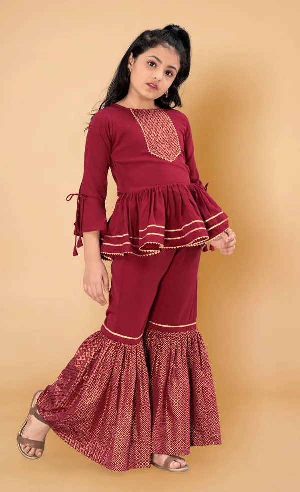 Maroon_Crepe_Peplum_Top_And_Sharara_Set_For_Girls