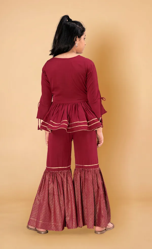 Maroon_Crepe_Peplum_Top_And_Sharara_Set_For_Girls