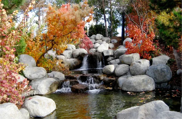 Waterfall_in_the_Rocks_in_the_Awesome_Blossom-_Nature_Theme_Wall_Decor,_Framed,_Multicolor
